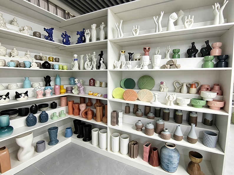 Curated ceramic collections under professional lighting at TYY china Dehua showroom, highlighting glaze textures and craftsmanship details