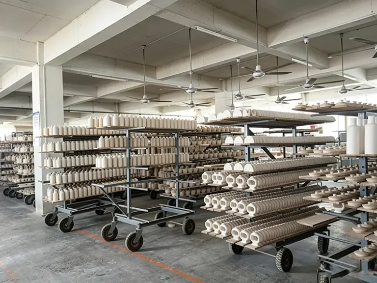 Ceramic greenware drying on racks in controlled humidity at TYY china factory Dehua