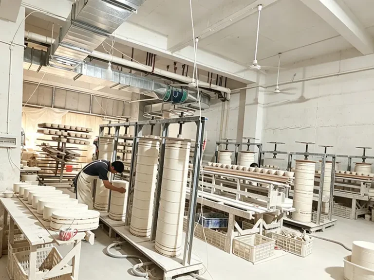 Ceramic slip casting process at TYY china factory, pouring liquid clay into plaster molds for precise shaping
