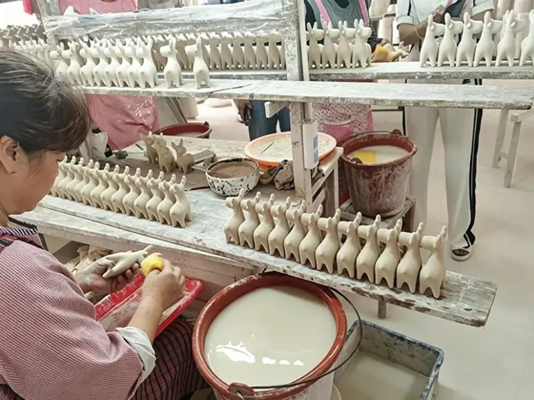 Washing and cleaning ceramic pieces after trimming at TYY china factory, removing dust before decoration