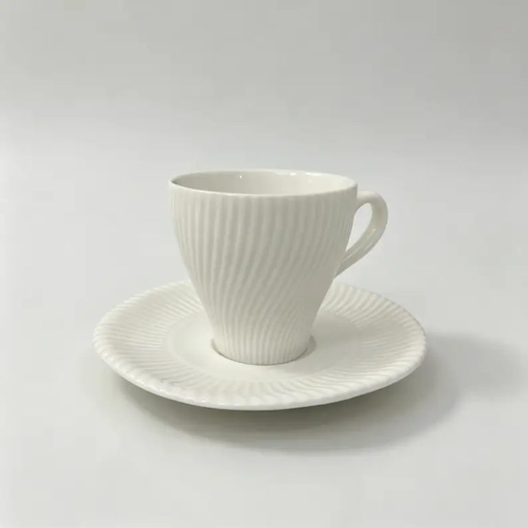 052g Spiral-textured ceramic coffee cup and saucer in white.