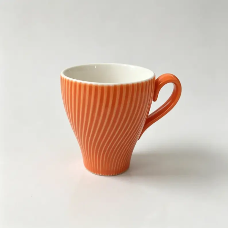052g Orange spiral-textured ceramic coffee cup and saucer.