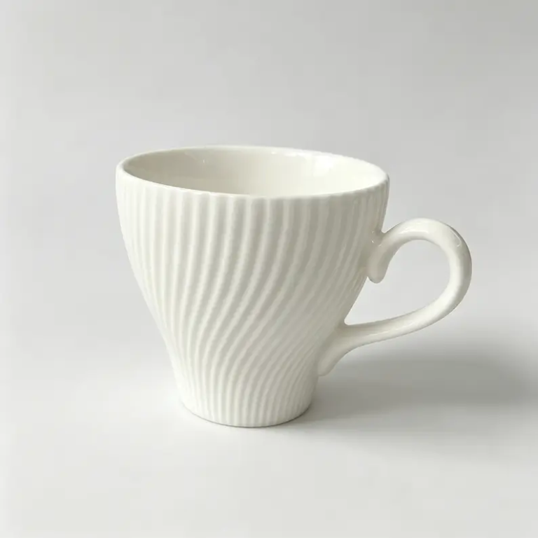 052g White spiral-textured ceramic coffee cup and saucer.