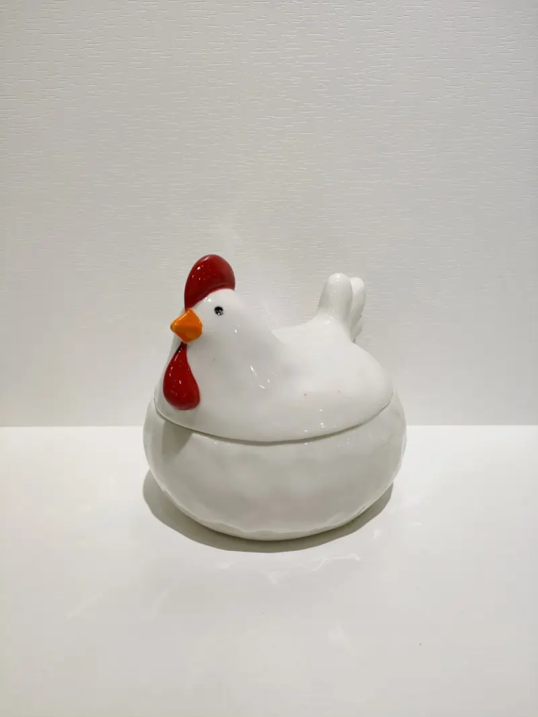 112D Chicken ceramic storage container with a removable lid shaped as a white chicken for Easter home organization and display.