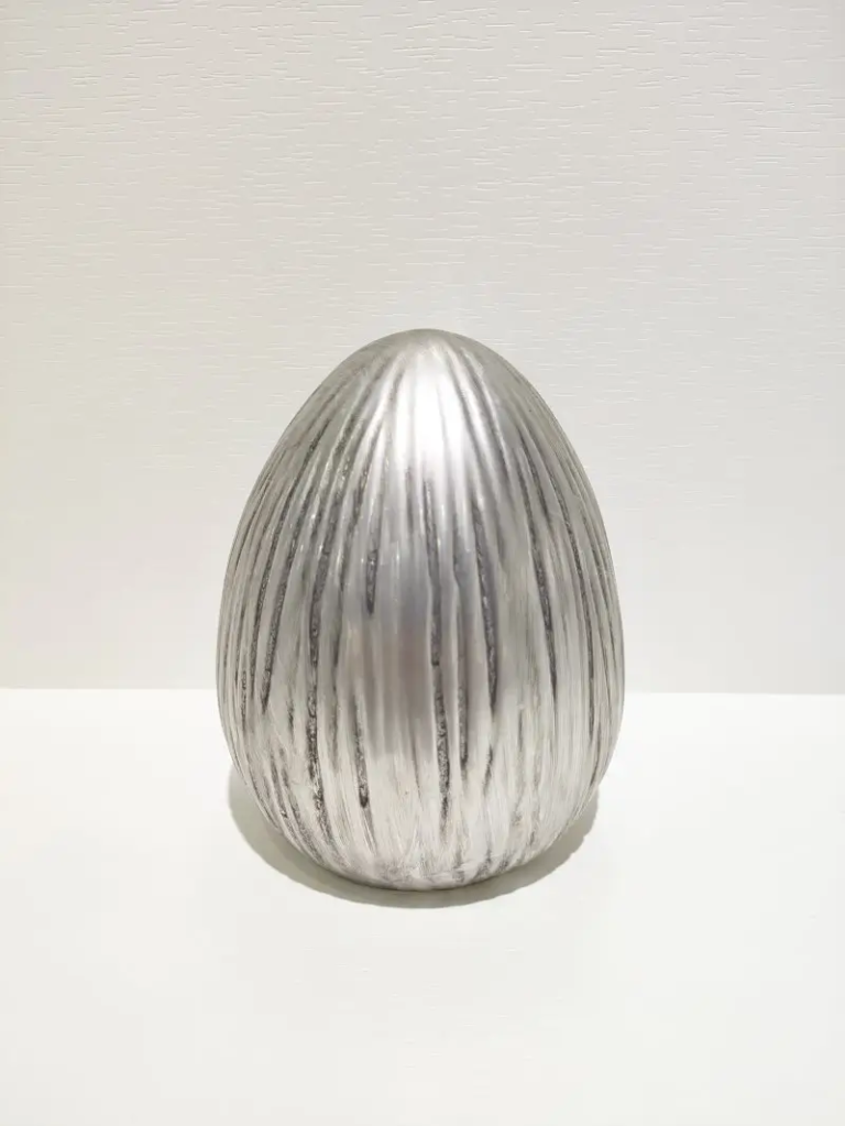 116D Silver ribbed egg ceramic ornament with vertical raised grooves and a metallic finish for Easter decorative displays.