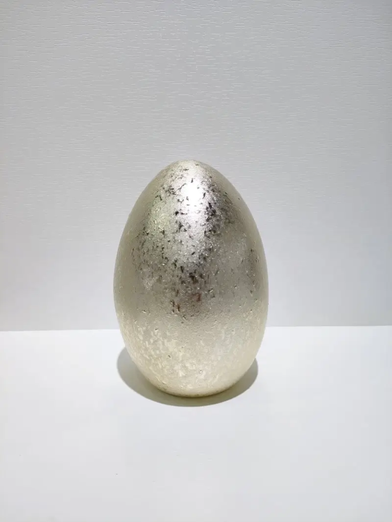 117D Antique gold speckled egg ceramic ornament with an irregular metallic surface effect for Easter decoration and seasonal displays.