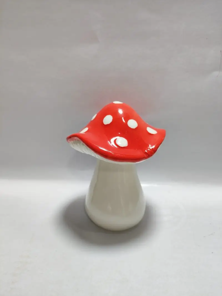 147D red ceramic mushroom decor with handcrafted painted spots and curved mushroom silhouette for decorative display.