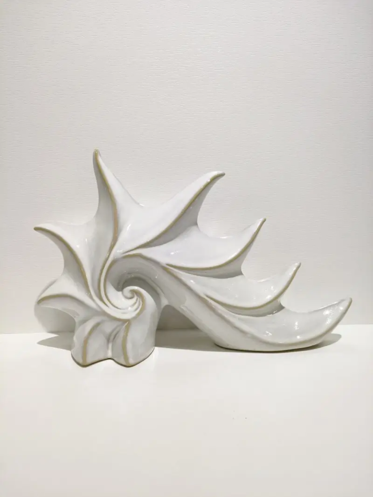 157D shell sculpture ceramic decor with flowing ocean inspired shape, creating an artistic focal point for interior decoration.