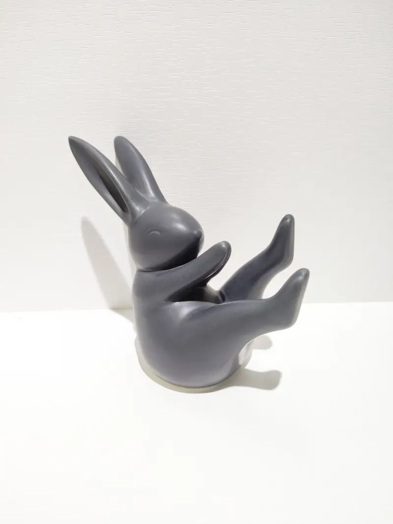 170D black ceramic reclining rabbit figurine with relaxed yoga inspired pose, matte finish decorative sculpture