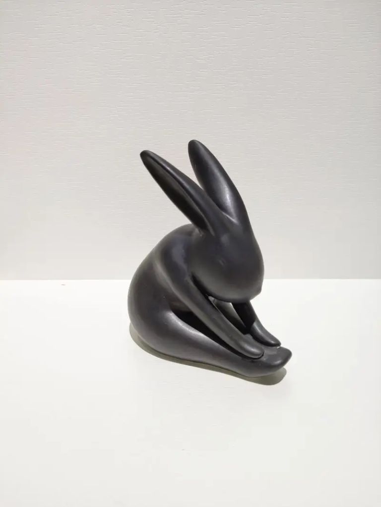 171D black ceramic rabbit figurine with curled resting pose, matte surface finish for modern interiors