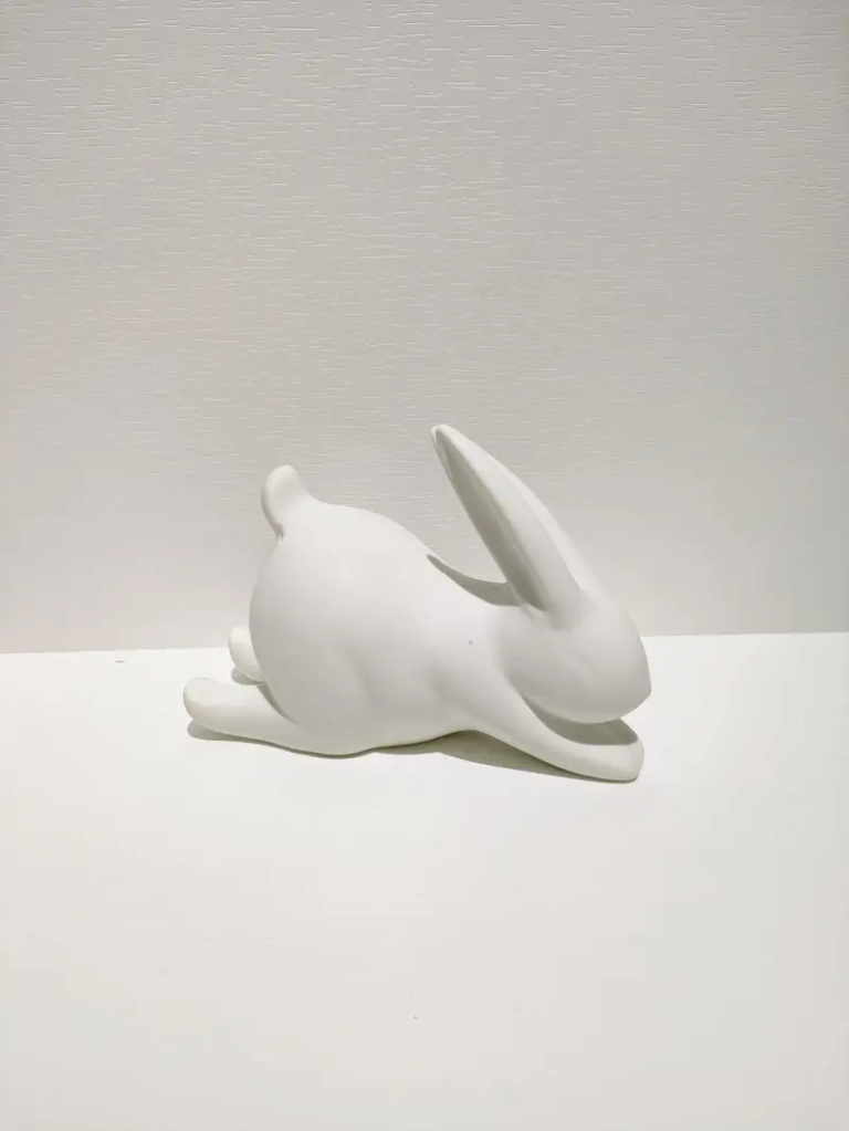 172D white ceramic reclining rabbit figurine with lying pose design, matte finish decorative home accent