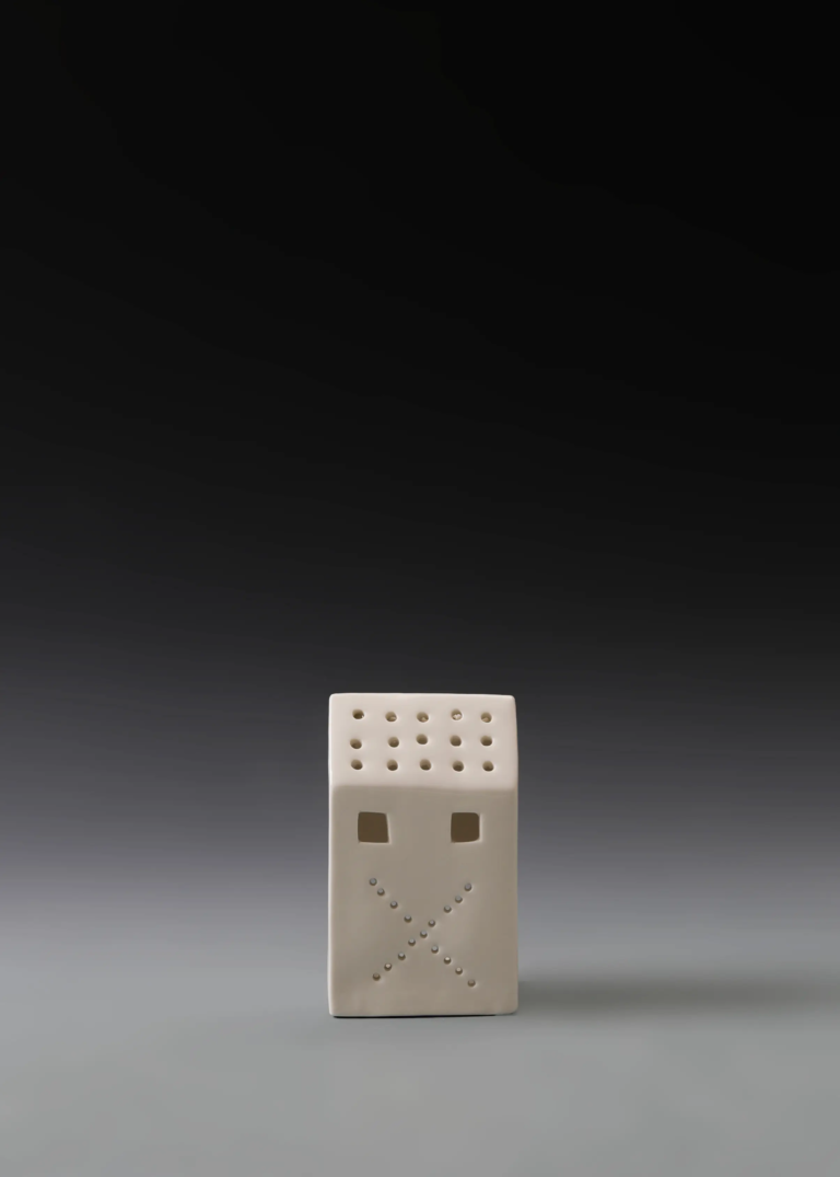 209A perforated wall house in matte white ceramic with multiple illuminated openings for Christmas decor