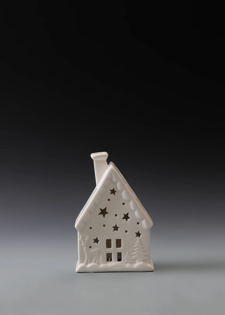 214A starry gable house in matte white ceramic with star cutouts and illuminated openings for Christmas village decor