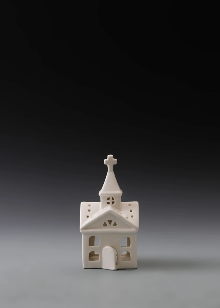 216A steeple gable house in matte white ceramic with a pointed steeple, cross detail and illuminated windows