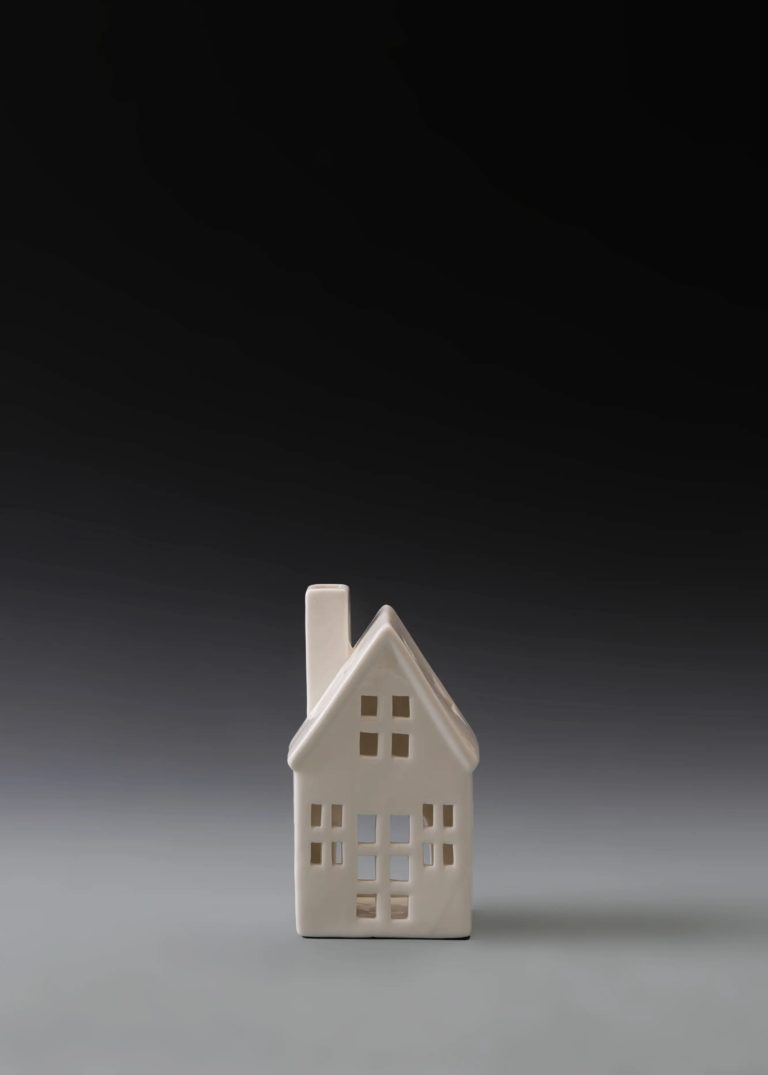 217A slim gable house in matte white ceramic with a narrow vertical profile and illuminated windows for Christmas village displays