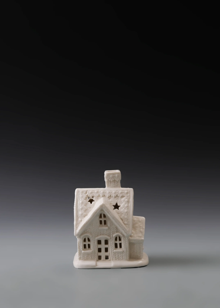 219A star gable cottage in matte white ceramic with layered roof details, star accents and illuminated windows