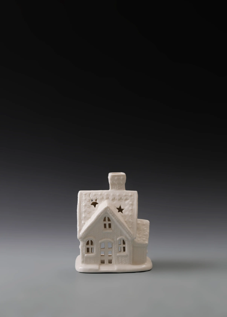 220A snowy gable cottage in matte white ceramic with a snow-covered roof effect and illuminated openings
