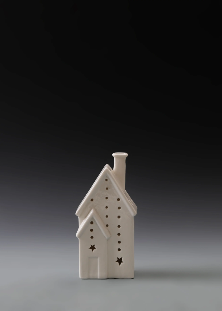 228A star side house in matte white ceramic with side star cutouts and illuminated openings for Christmas village displays