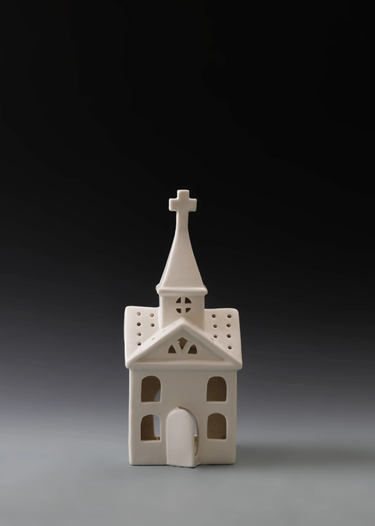 229A grand steeple house in matte white ceramic with a tall church-inspired structure and illuminated windows