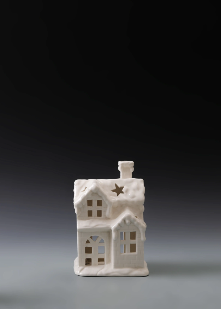 232A snow gable house in matte white ceramic with layered snowy roof forms and illuminated openings