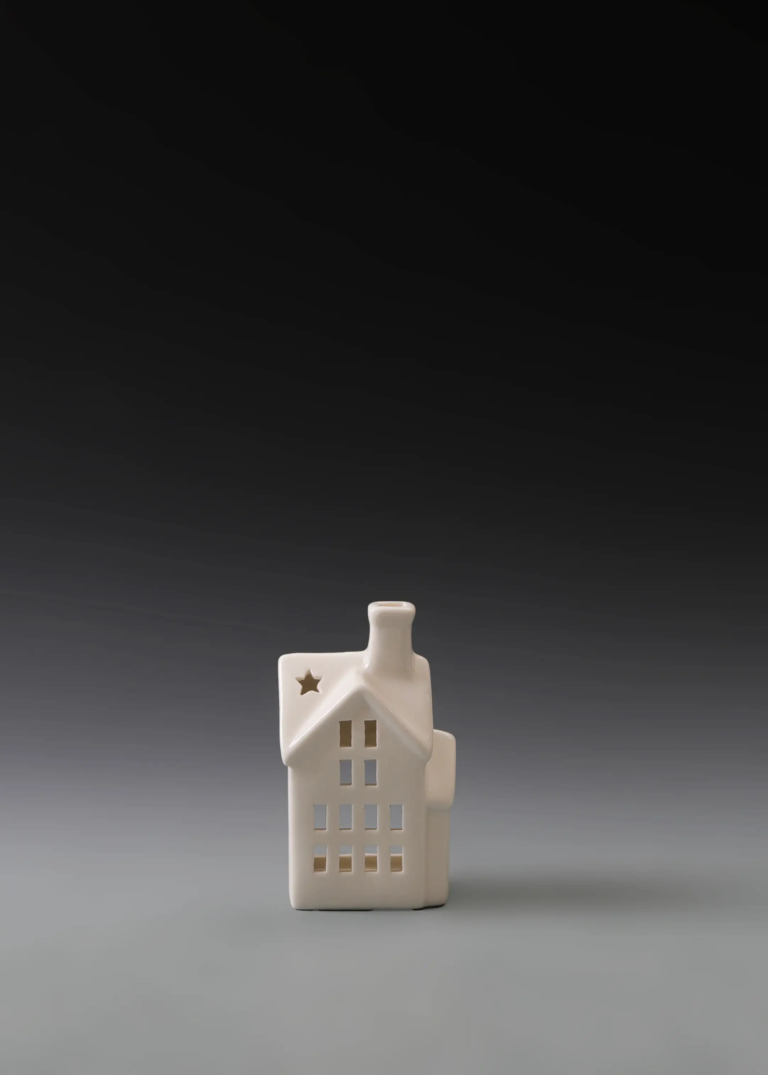 237A petite window house in matte white ceramic with a compact narrow form and multiple illuminated windows.