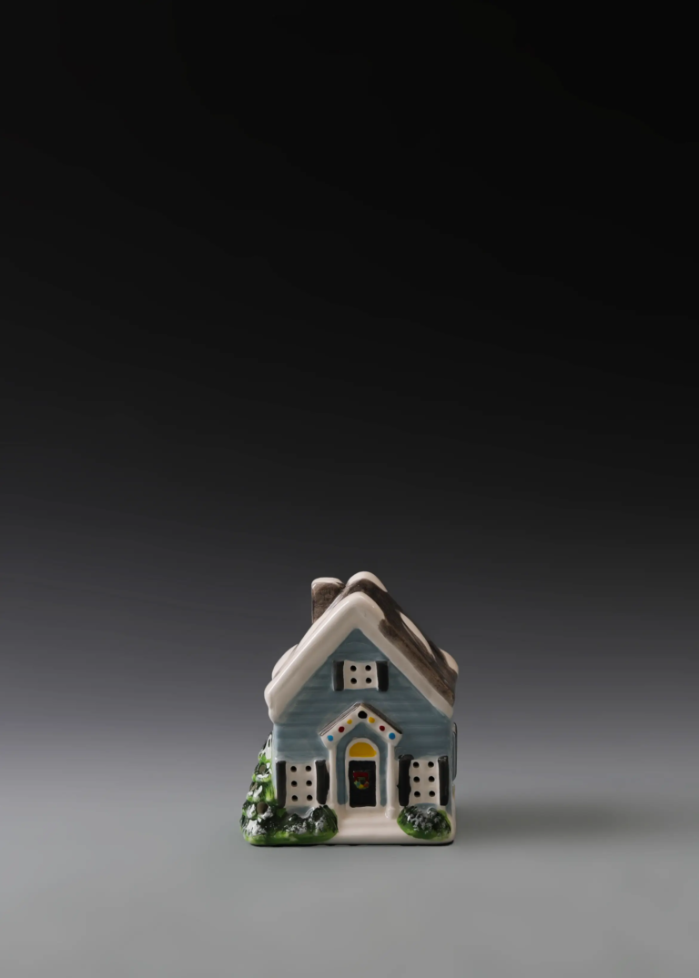 238A blue holiday cottage in hand-painted multicolor ceramic with festive accents and illuminated windows