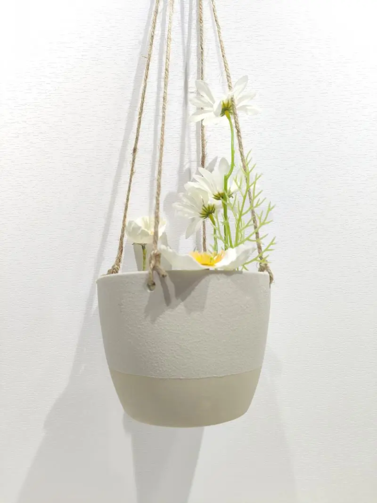 358D cream ceramic hanging planter with warm neutral tone and smooth ceramic finish, creating a natural decorative plant display.