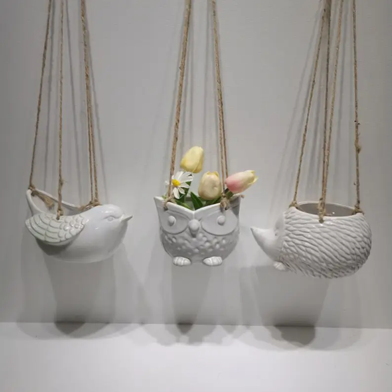 Animal and patterned hanging ceramic planter collection with decorative shapes and reactive glaze finishes