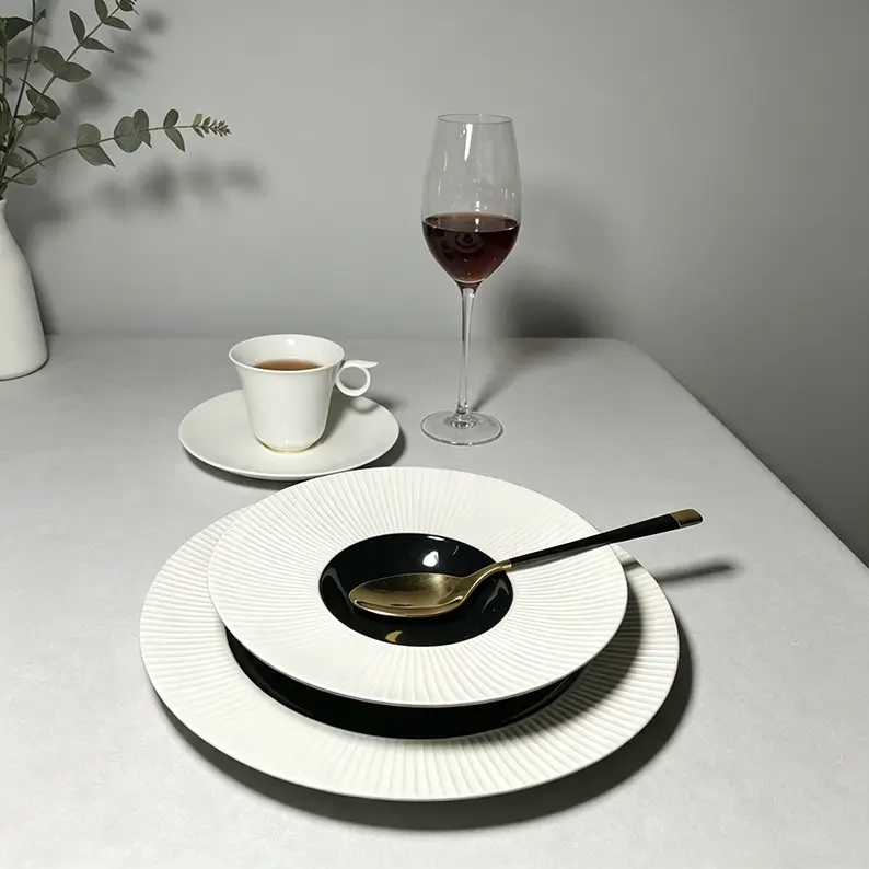 Black, white and black and white fluted ceramic plates with dense radial texture