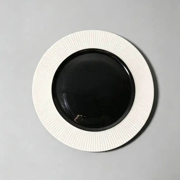 Black and white narrow rim fluted ceramic plate with contrasting colors and fluted texture