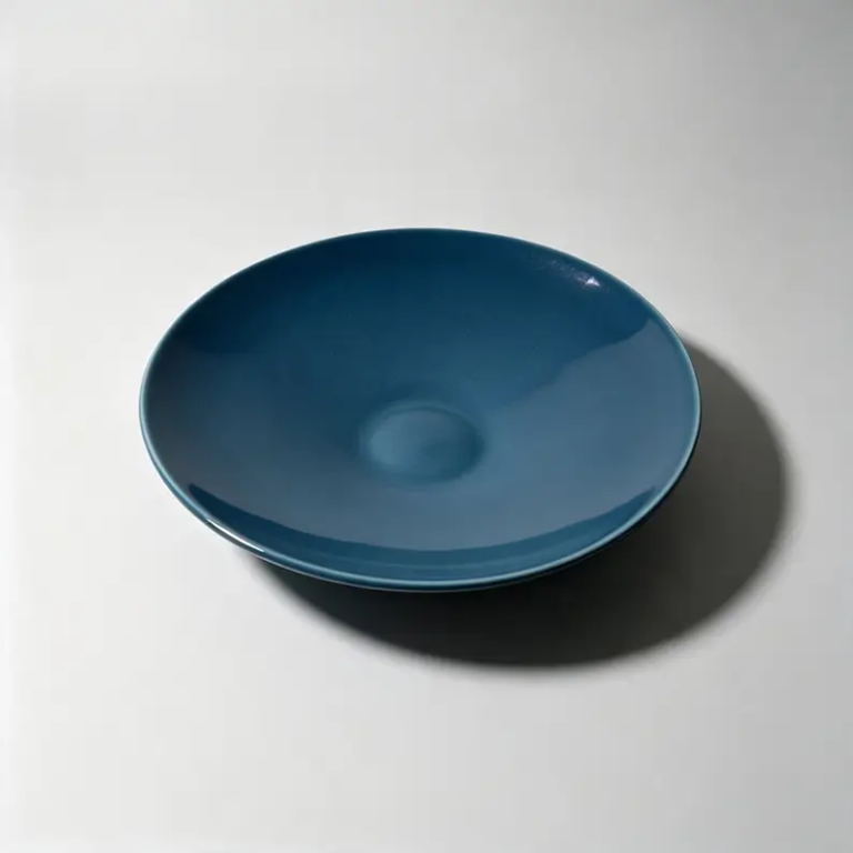Blue 10-inch coupe ceramic plate with a glossy glazed surface