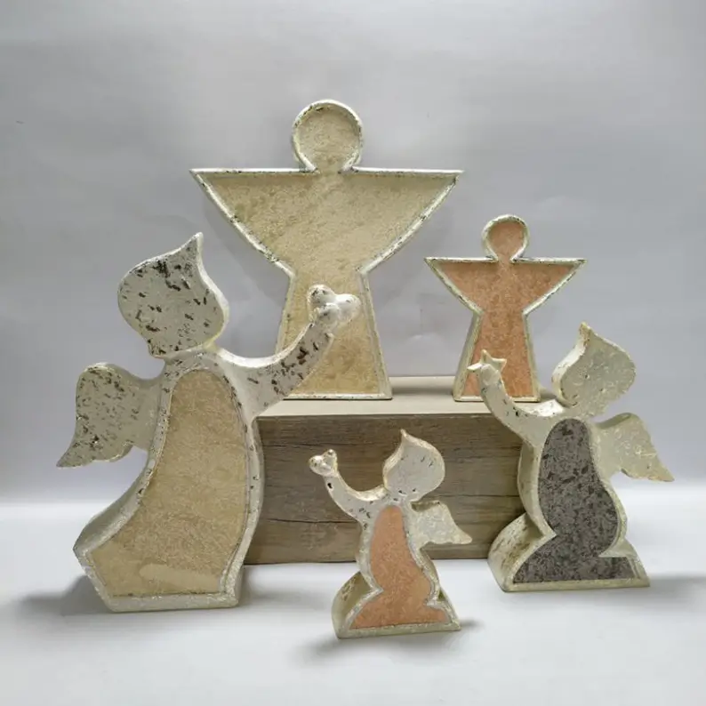 Ceramic angel figurines with textured metallic finishes in geometric and sculptural angel forms
