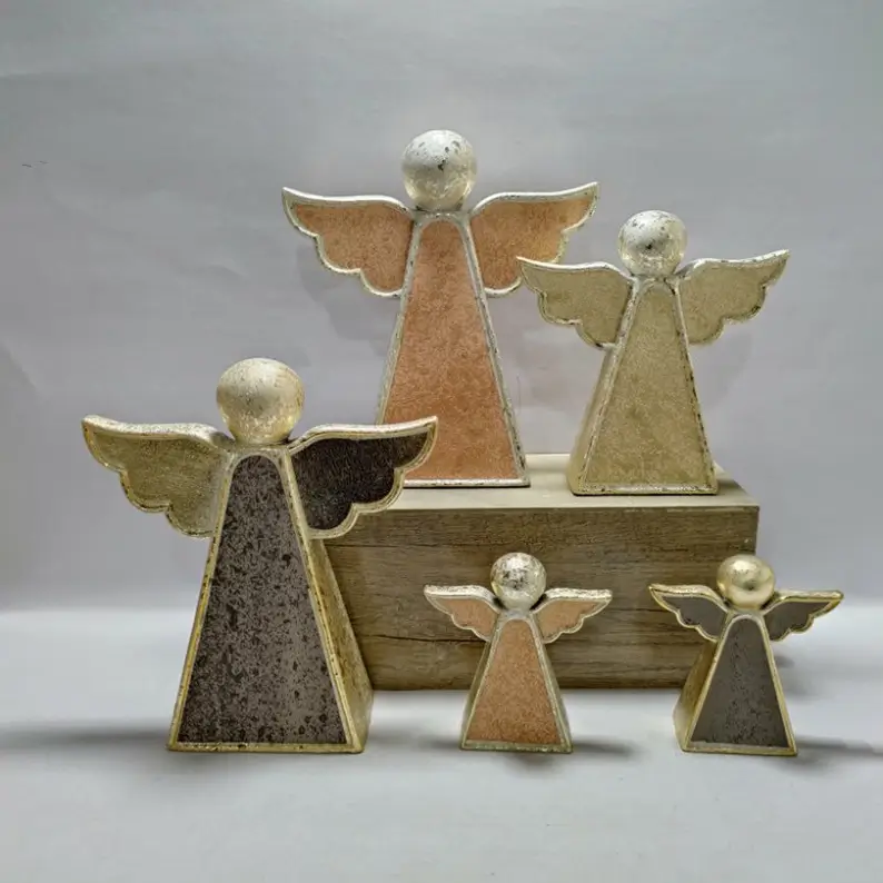 Ceramic angel figurines with textured metallic finishes in geometric and sculptural angel forms.