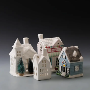 White and hand-painted multicolor ceramic Christmas houses showing two distinctive holiday display styles