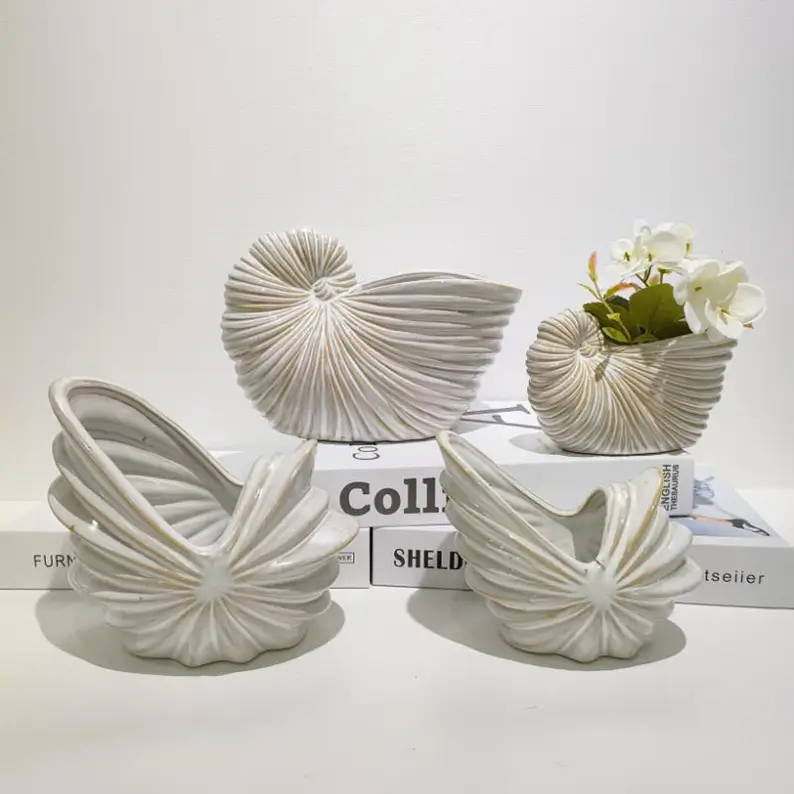 Nautilus shell ceramic storage containers with spiral shell details, providing functional organization and decorative value for modern interiors.