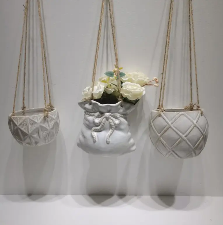 Decorative hanging ceramic planter featuring animal inspired forms and patterned ceramic surfaces