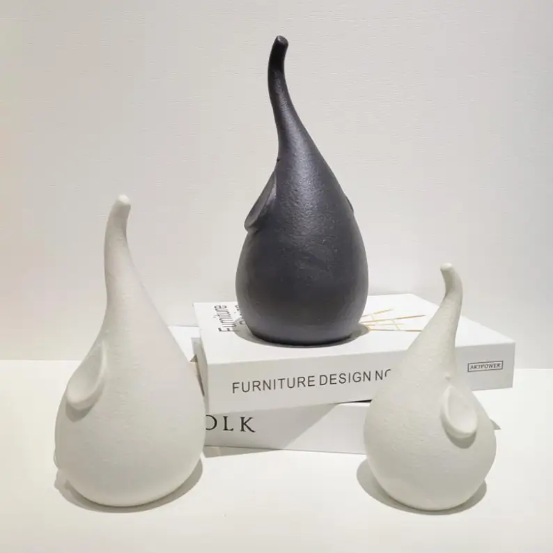 Elephant ceramic decorative figurines highlighting unique silhouettes, curved trunks, and artistic ceramic forms