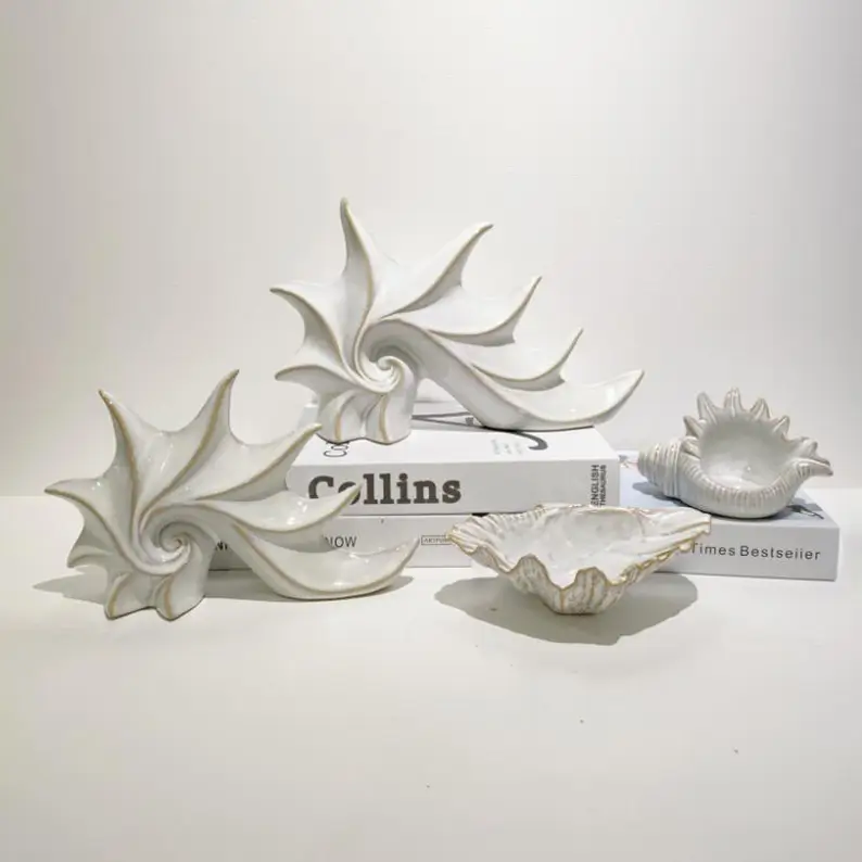 Sculptural ceramic shell decor with organic ocean inspired forms and detailed surface textures, designed for elegant home, hotel and commercial interiors.