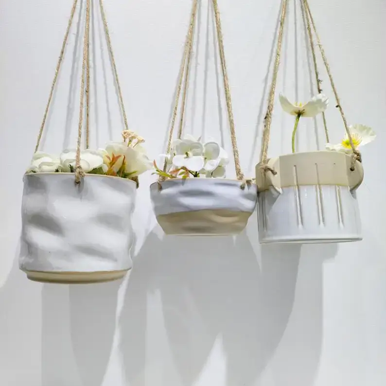 kiln changed ceramic hanging planters featuring varied shapes, finishes and artistic surface designs for contemporary plant decoration