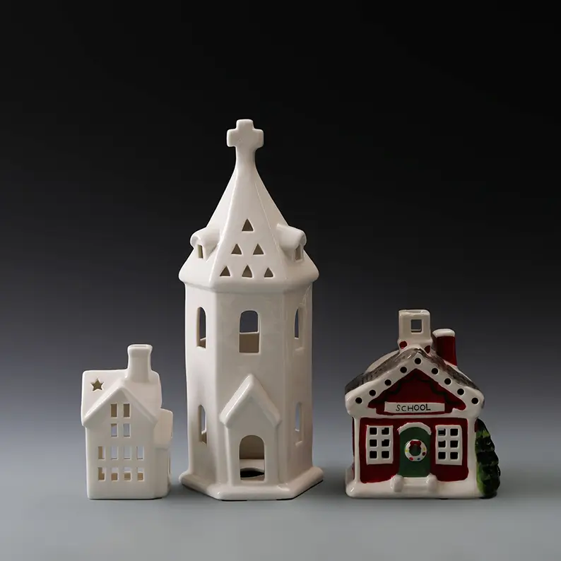 Ceramic light-up Christmas houses featuring gable roofs, snowy details, star accents and varied architectural silhouettes