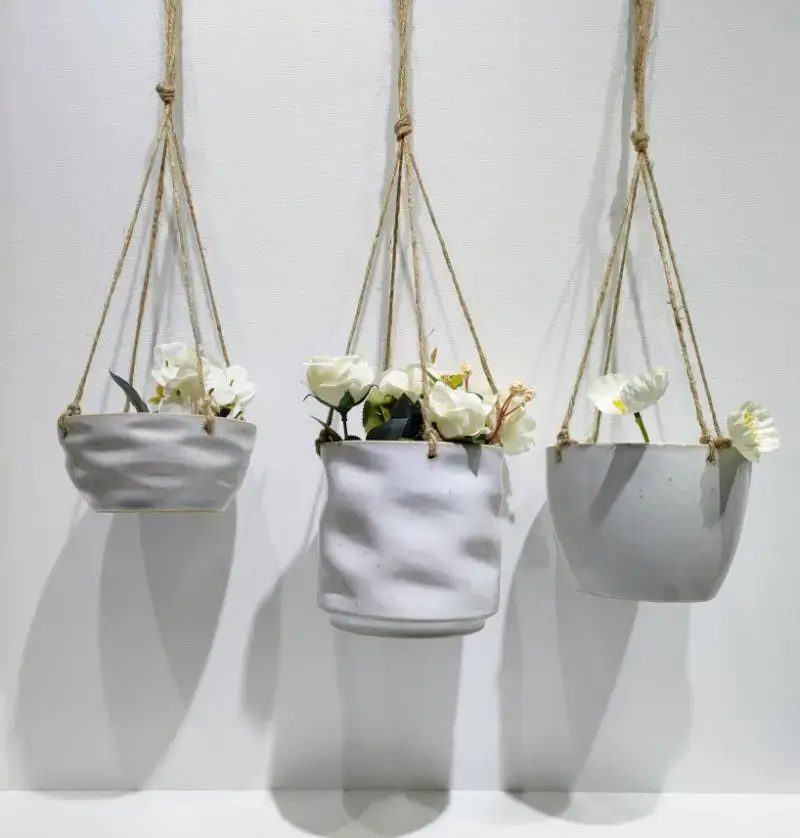 Hanging ceramic planter set combining glossy, matte and textured surface effects with different styles for home, balcony and garden decoration