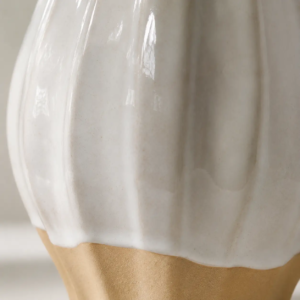 Close-up view of ceramic vase surfaces showing natural two-tone variations created by reactive glaze firing