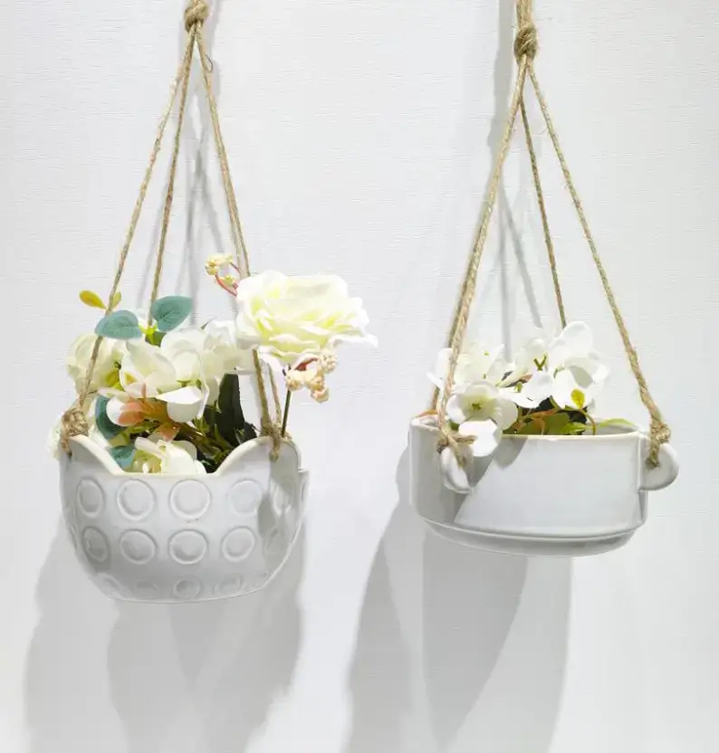 Hanging ceramic planter collection featuring reactive glaze finishes, natural kiln-fired variations and handcrafted ceramic details for indoor and outdoor plant decoration