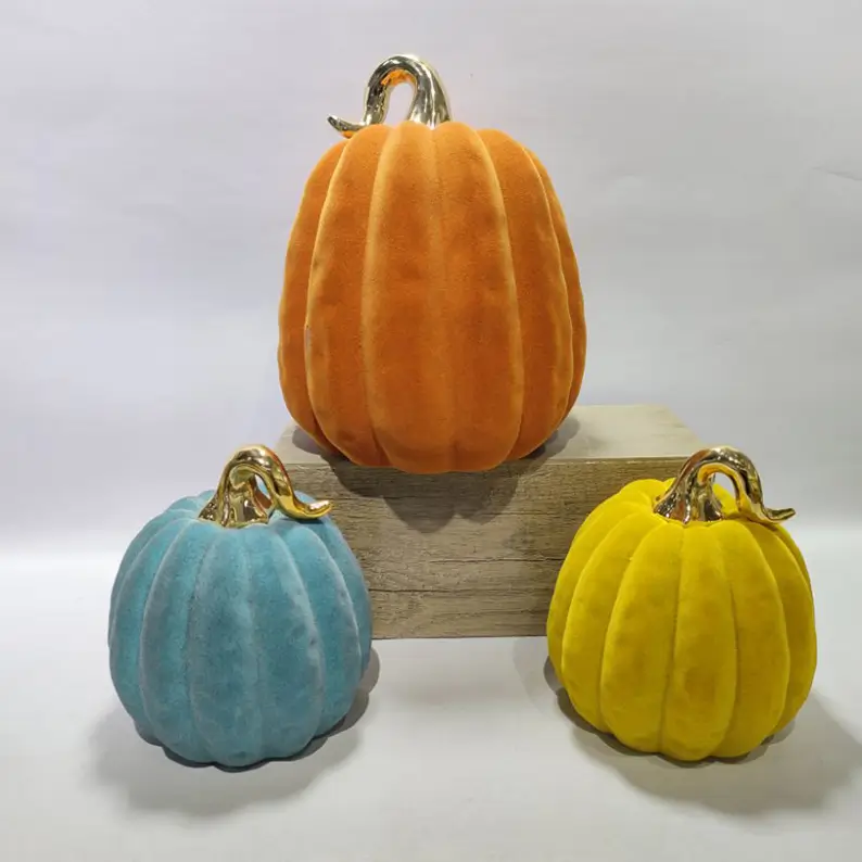 TYY2503 flocked pumpkin decorative figurines in orange, blue, and yellow with electroplated stems for Halloween seasonal decoration.