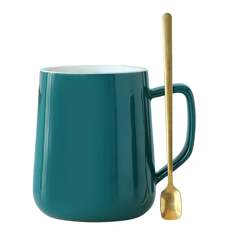 Ceramic mug with matching spoon showing glossy surface, simple handle design and modern silhouette.