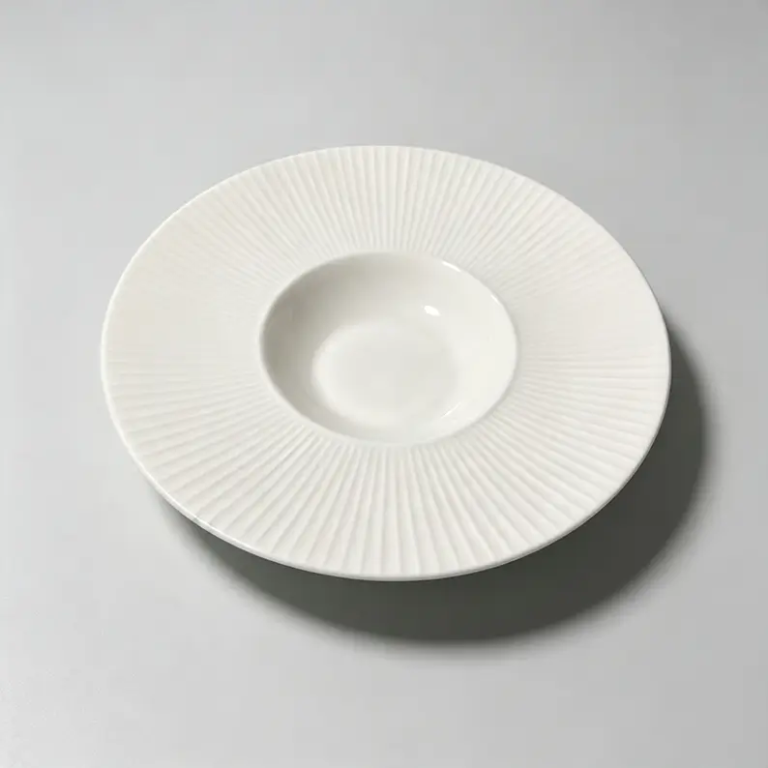 White fluted hat rim ceramic plate with raised rim design and radial texture