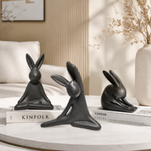 Yoga rabbit ceramic figurines arranged in a minimalist interior setting, showcasing unique yoga poses, sculptural forms, and modern home decor styling.