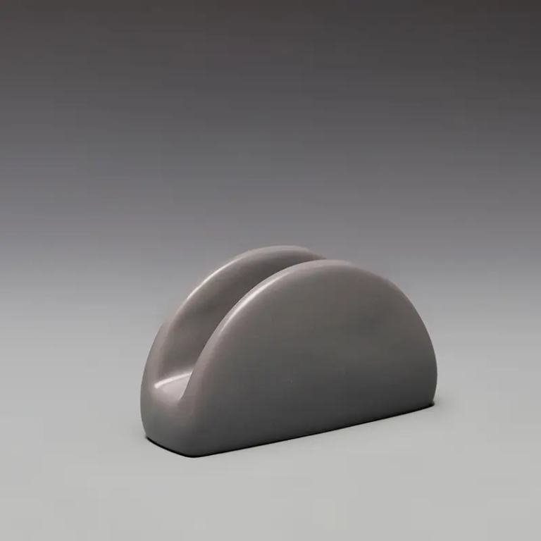 017A gray ceramic napkin and hand towel holder with a compact rounded design for organized tabletop use.